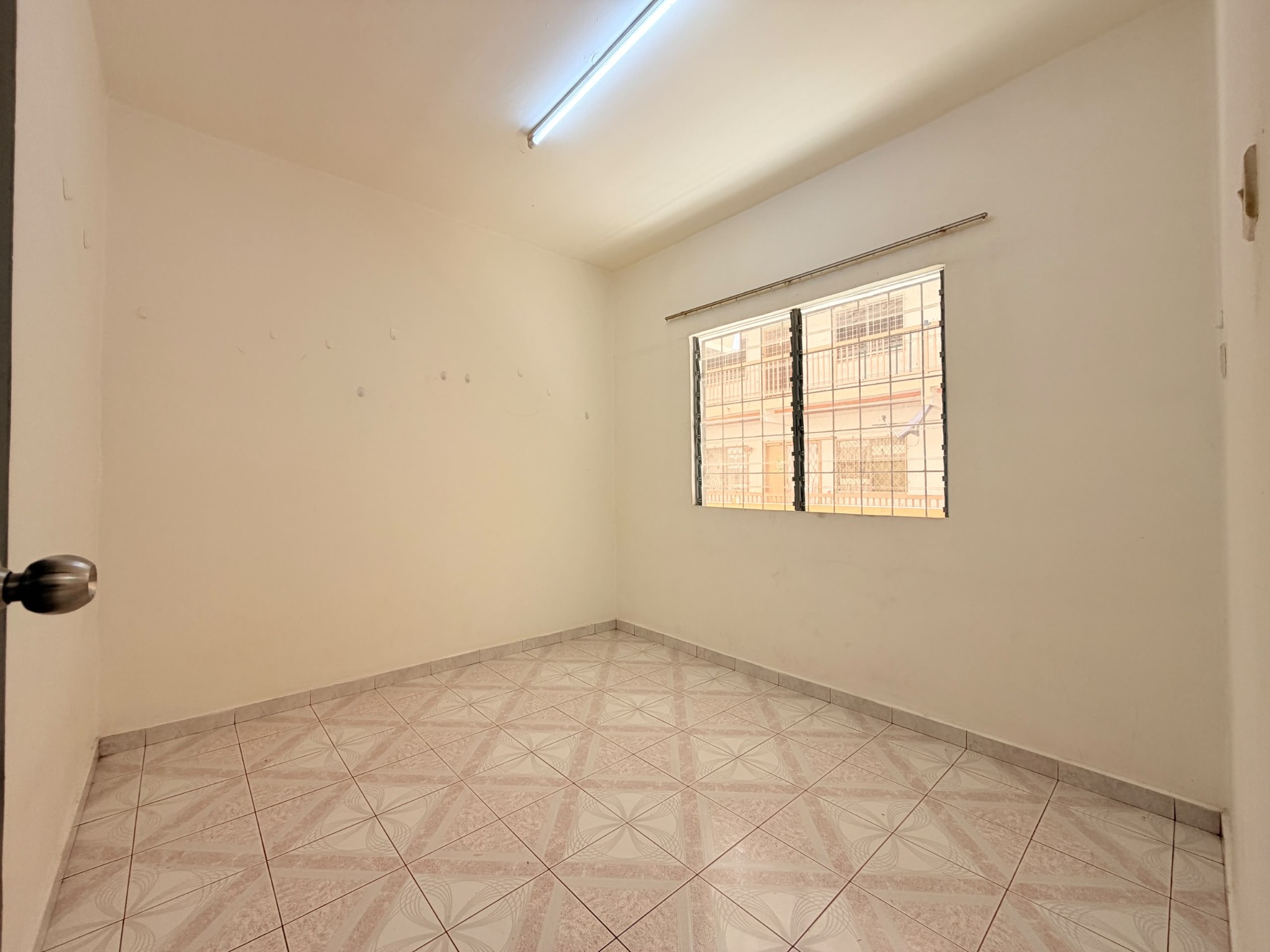 Bedroom with a wide window at Telipok Ria Apartment